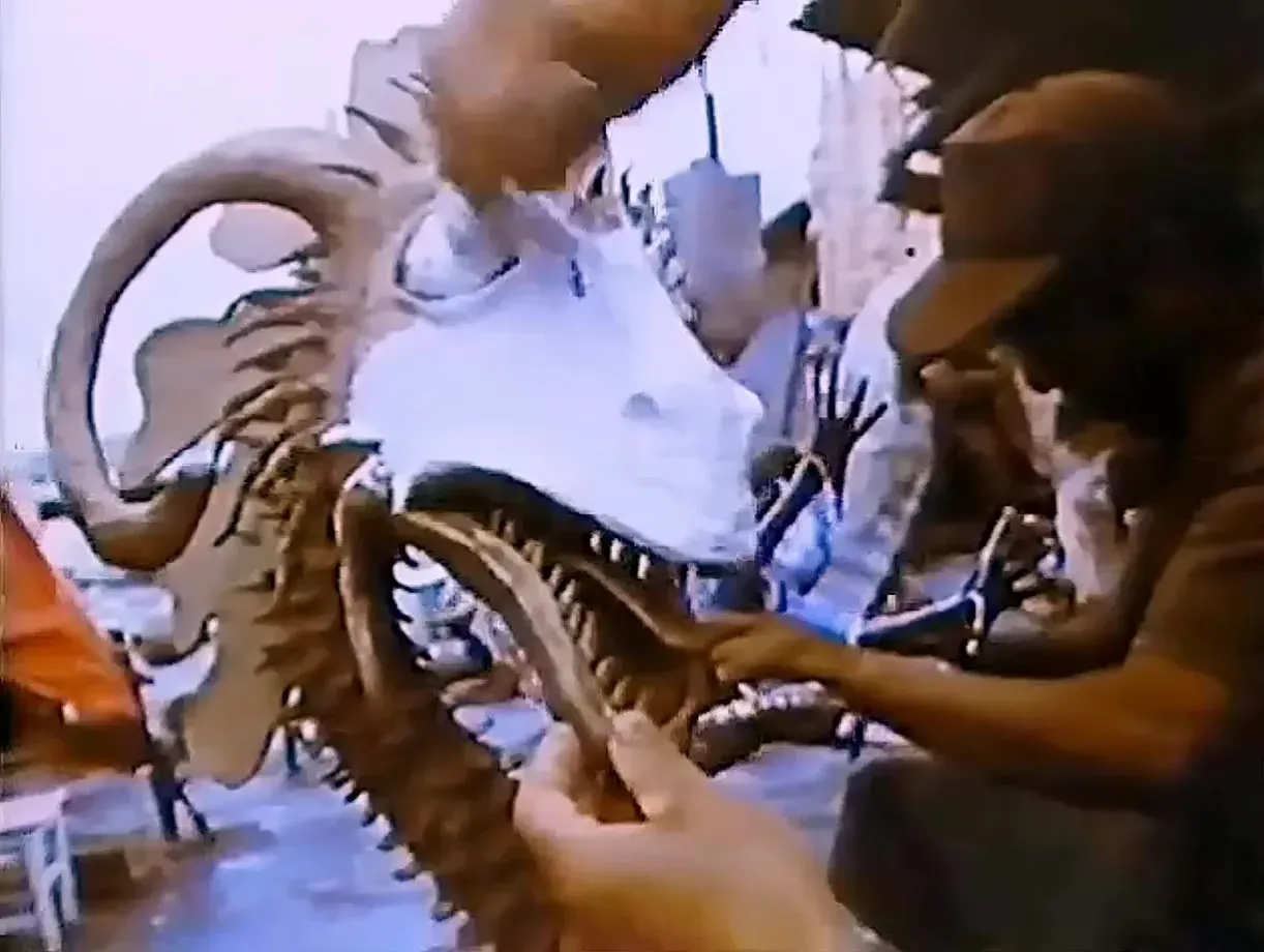 A white dragon head held in the hands; Pedro Linares in the background, in 1975.