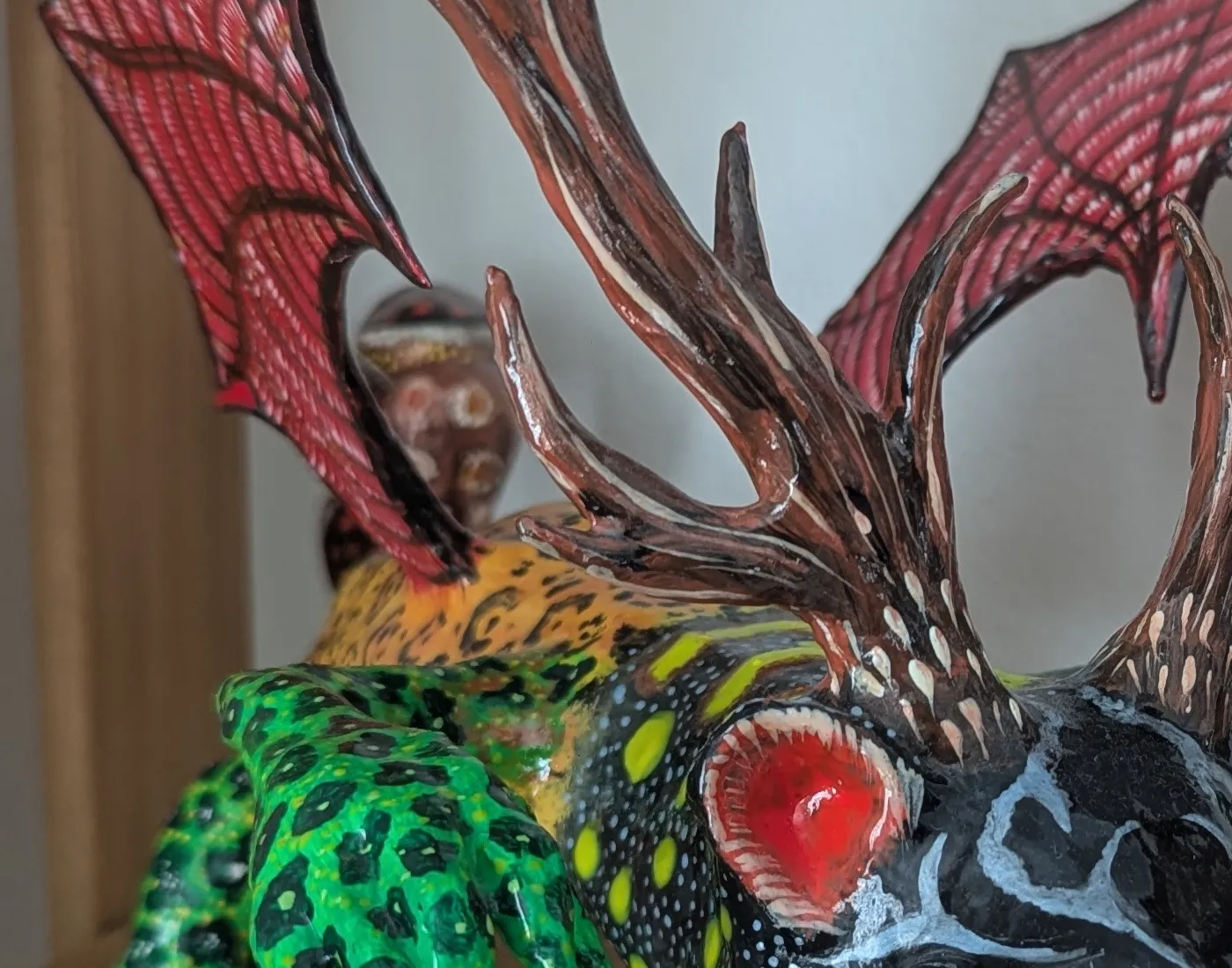 Red bat wings with veins traced in white over the dry paint.