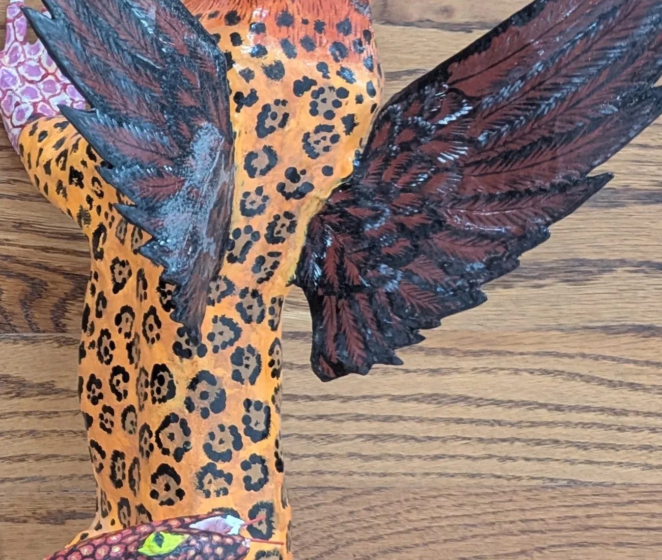 Black rosettes on orange along the whole body.